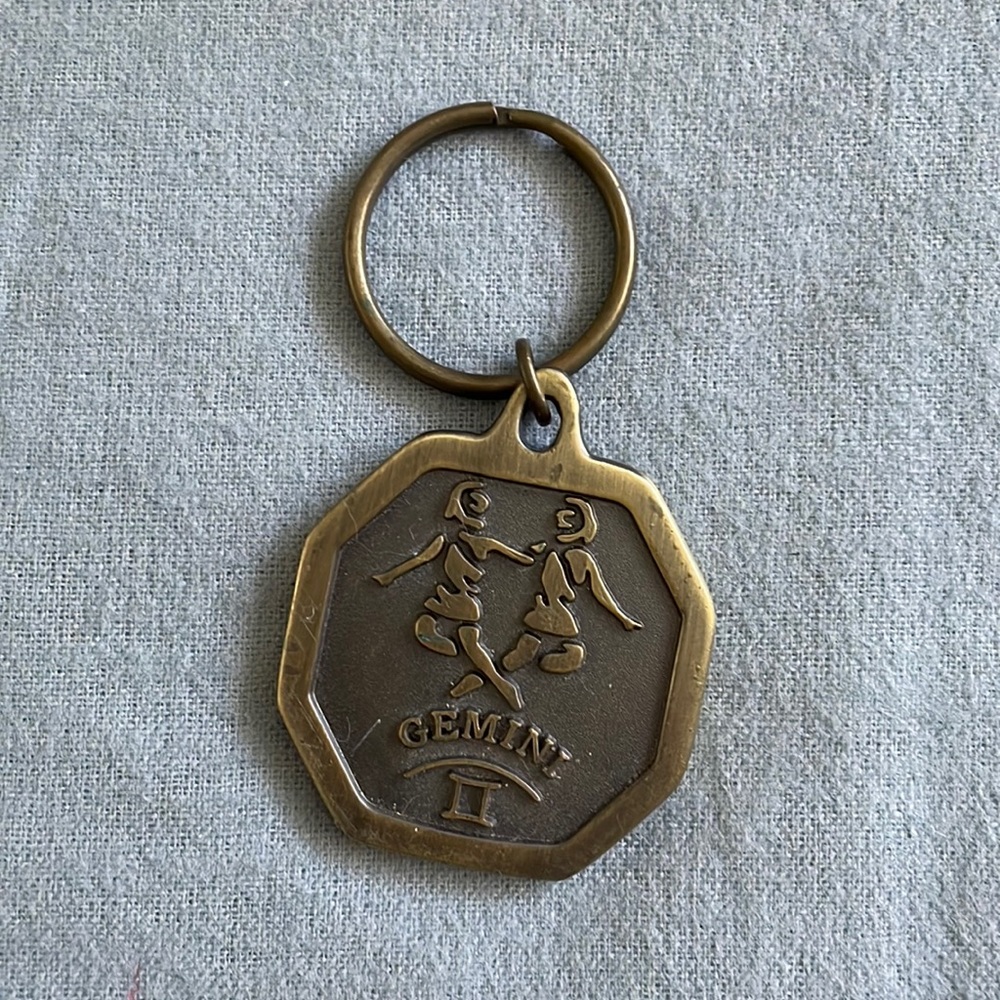 Gemini bronze tone key chain